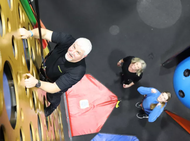 family climbing children and adults