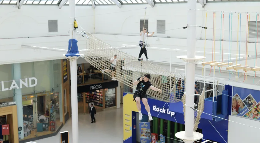 High Ropes course with zip line and climbers